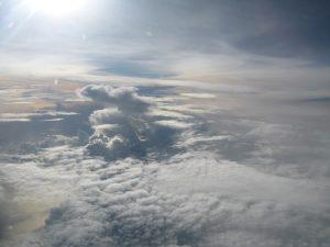 Clouds seen from above with bright sunlight shining across the scene.