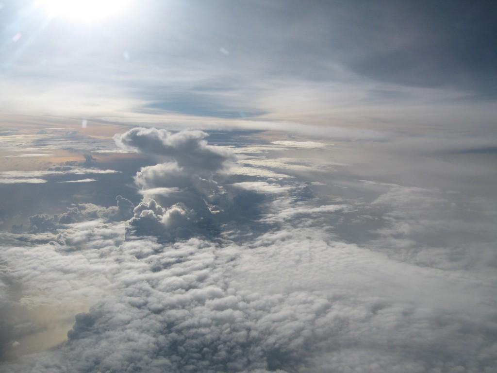 Clouds seen from above with bright sunlight shining across the scene.